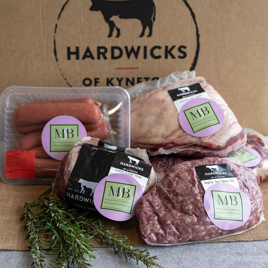 Mount Bolton Springs Wagyu packaged meats displayed with butcher partners Hardwicks of Kyneton branding on a cardboard box background.